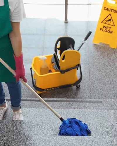 Cleaning cart and mop on a polished office floor