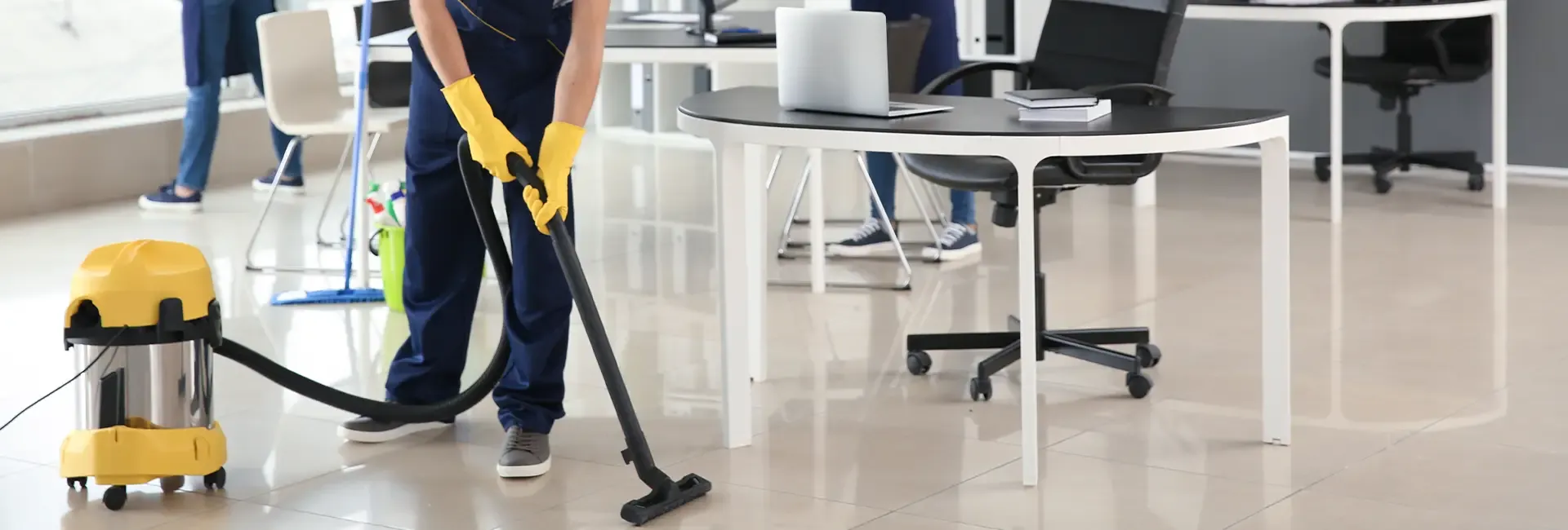 Professional vacuuming a modern office floor