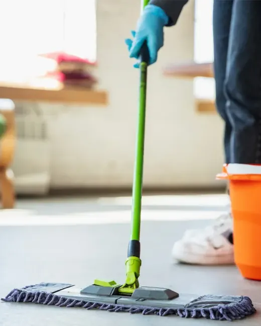 Flat mop cleaning a light wood floor